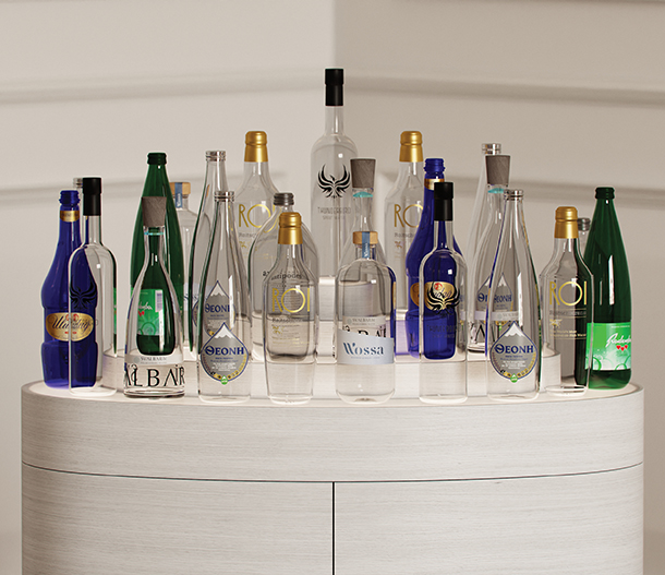 A close-up view of a variety of colorful, luxury natural water bottles on a light wood veneer display unit.